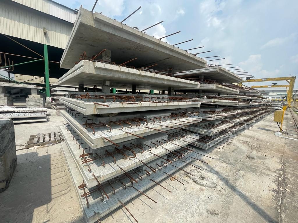 Stacked precast gable end wall panels with projecting reinforcement