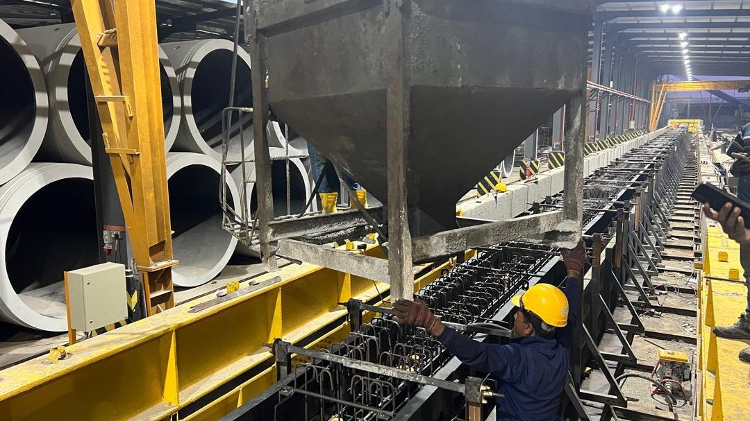 Concrete being discharged from a skip into a precast mould line in the casting bay